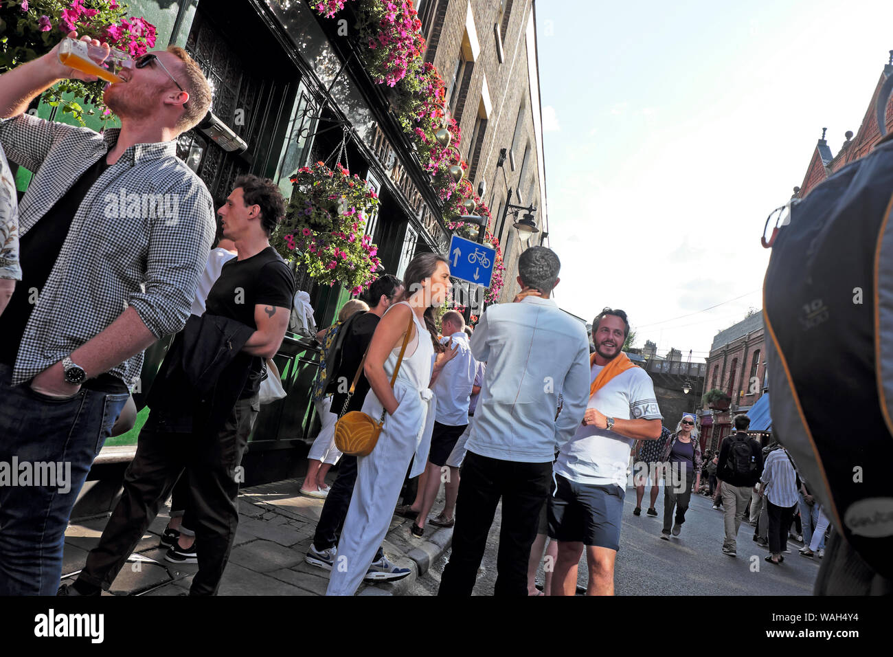 People friends drinking and talking outside Market Porter pub Borough Market on Stoney Street in Southwark South London SE1 England UK  KATHY DEWITT Stock Photo