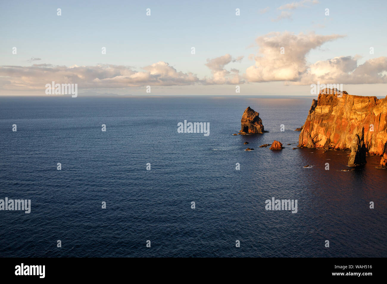 Miradouro da Ponta do Rosto | Madeira Portugal | Red Cliffs | Porto Santo in the Distance Stock Photo