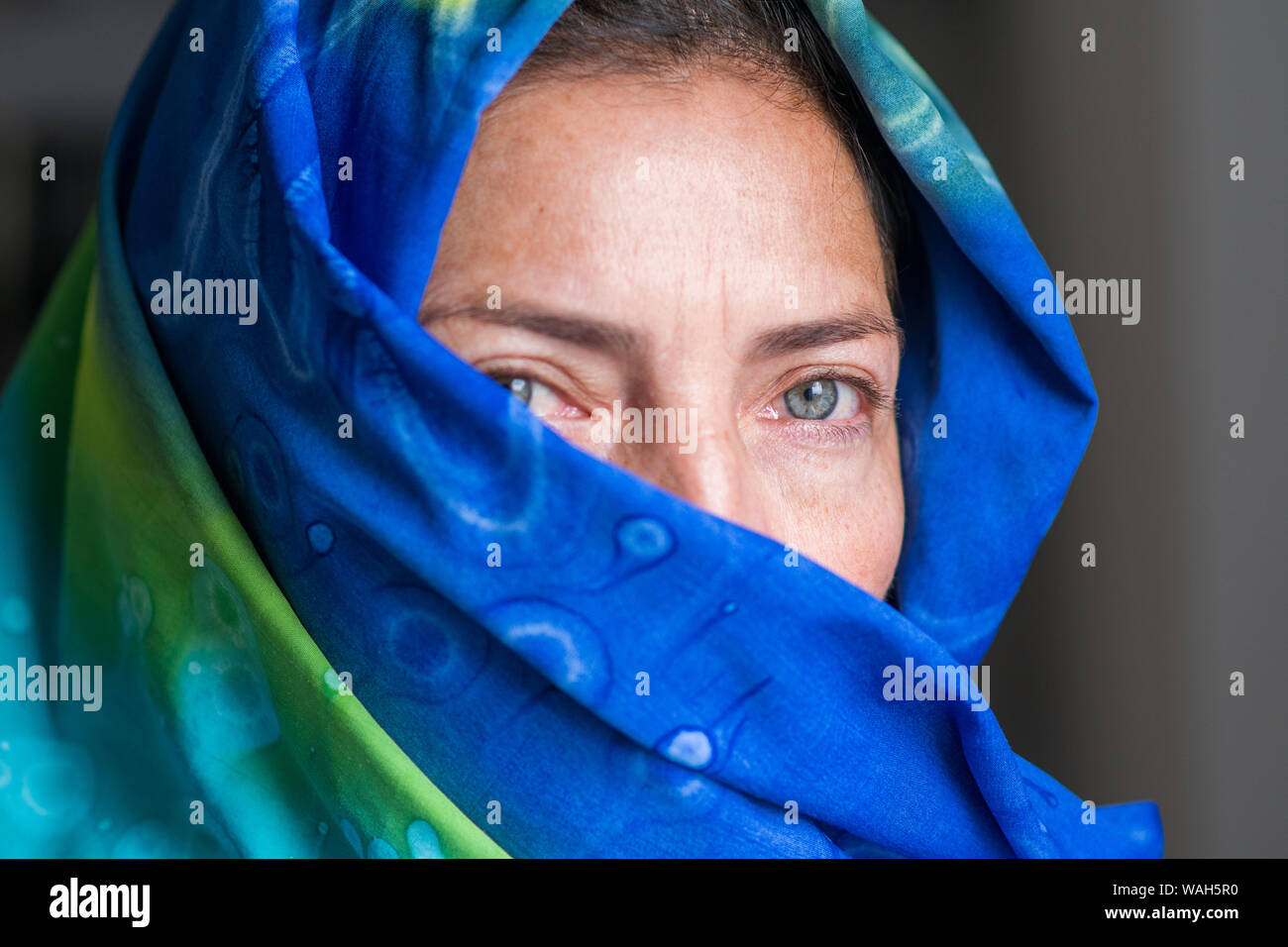 Pale green eyes woman portrait wearing a colorful burka Stock Photo