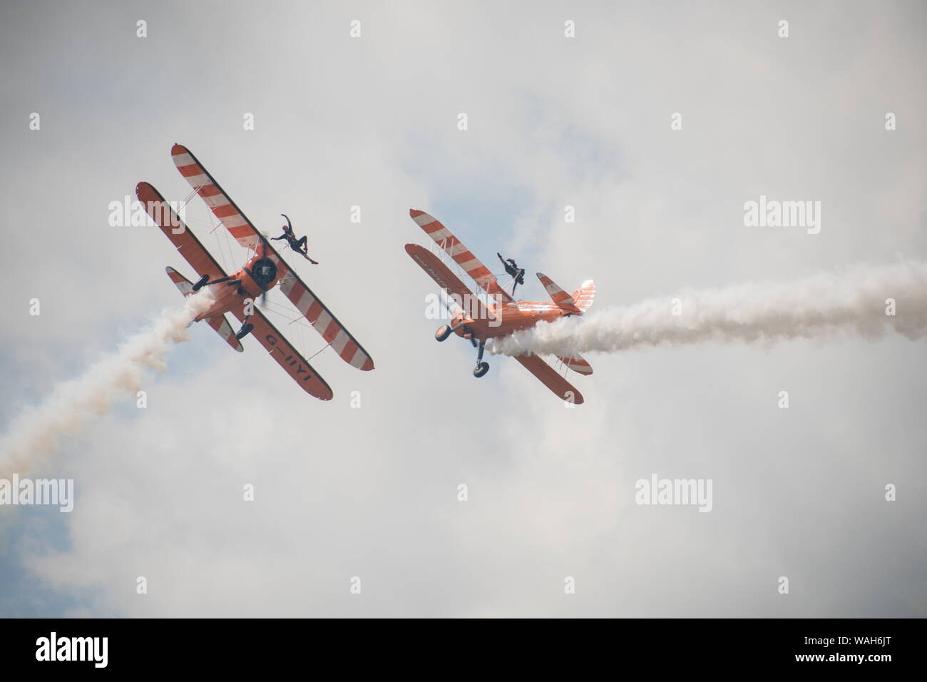 Aerobatic Formation Wingwalking display by Aerosuperbatics team formerly the Breitling Wingwalkers, Crunchie Flying Circus and Utterly Butterfly team Stock Photo