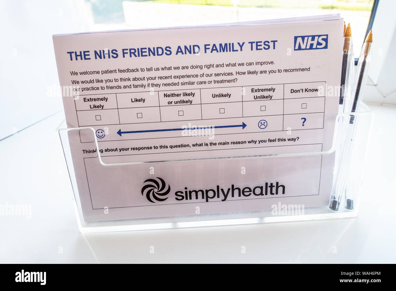 The NHS Family and friends test form in holder at Dentists Surgery in England Stock Photo