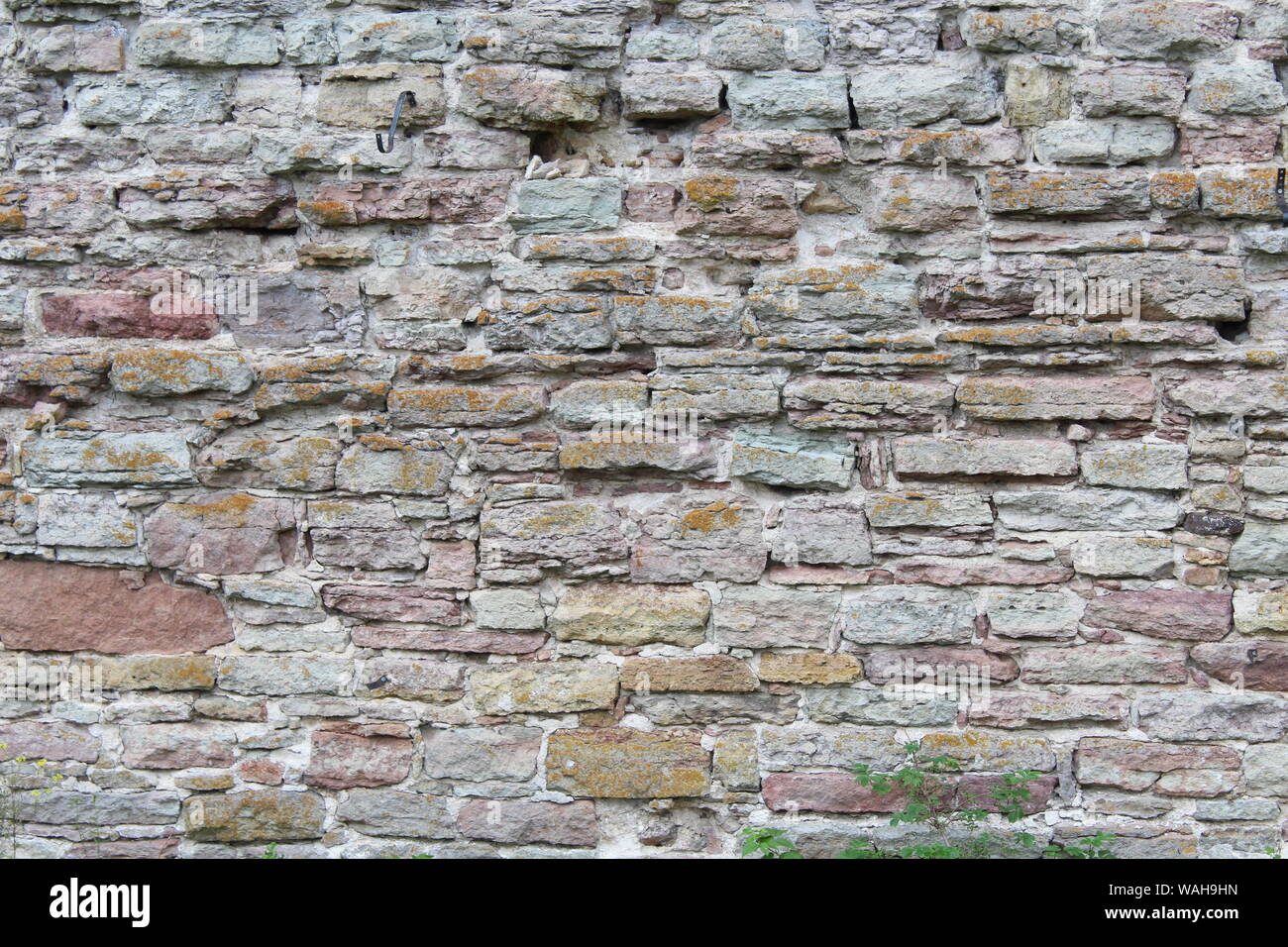 Destroyed by time and precipitation brick wall. The Background of old vintage brick wall Stock Photo