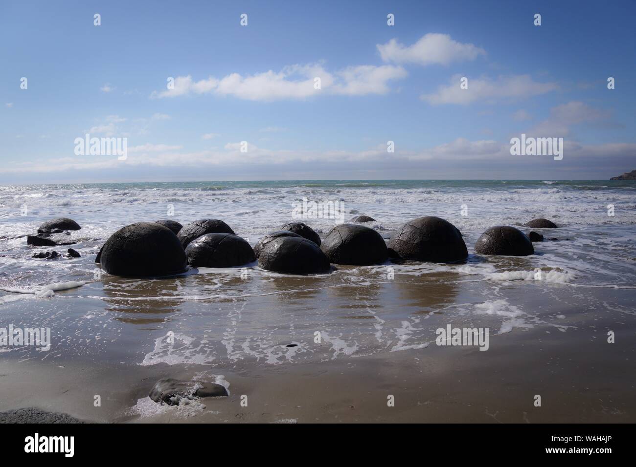 Round boulders on the beach between Hampden and Moekaki Stock Photo