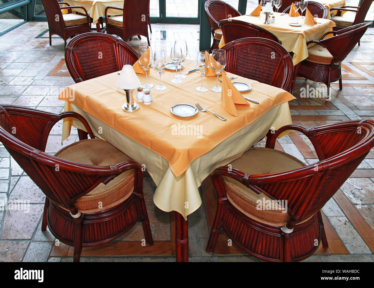 Restaurant table with complete tableware setup Stock Photo - Alamy
