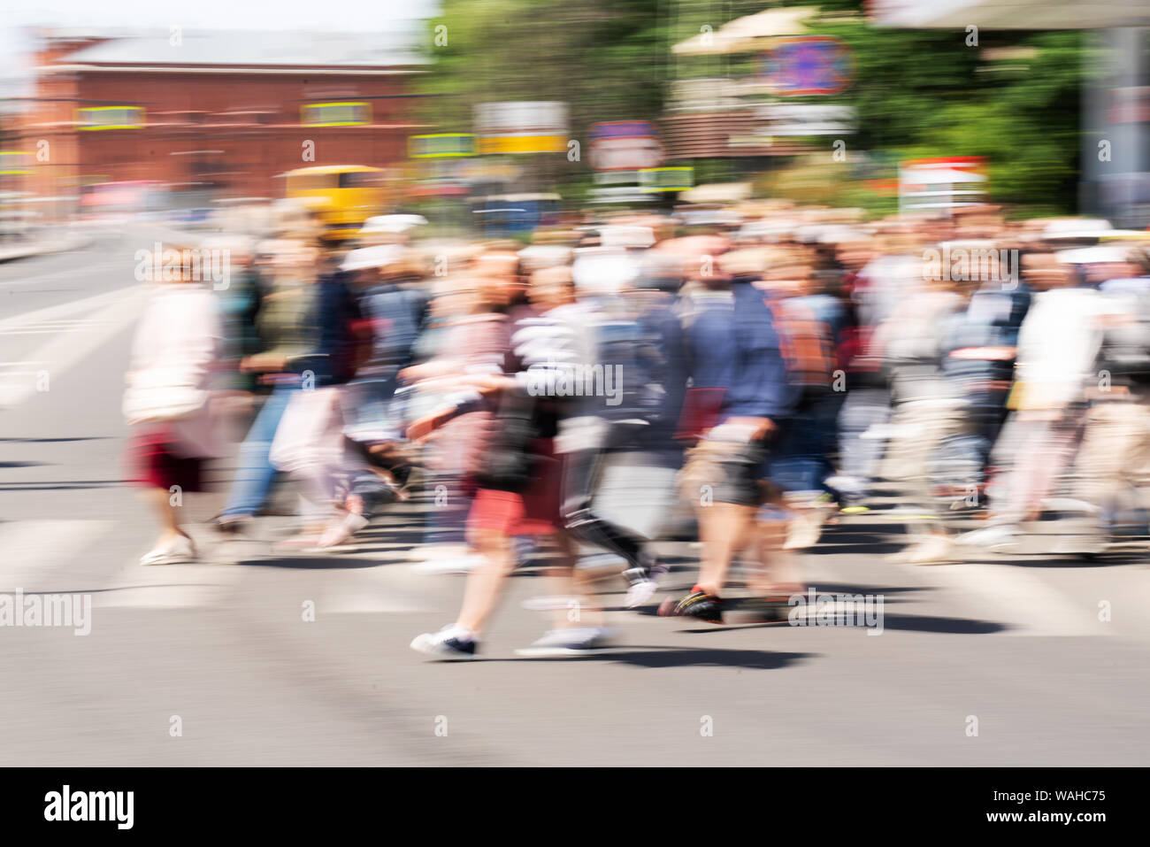 Blured crowd of people walking on the busy city street. Motion blured people. Slow shutter speed. People silhouette on the street. Stock Photo