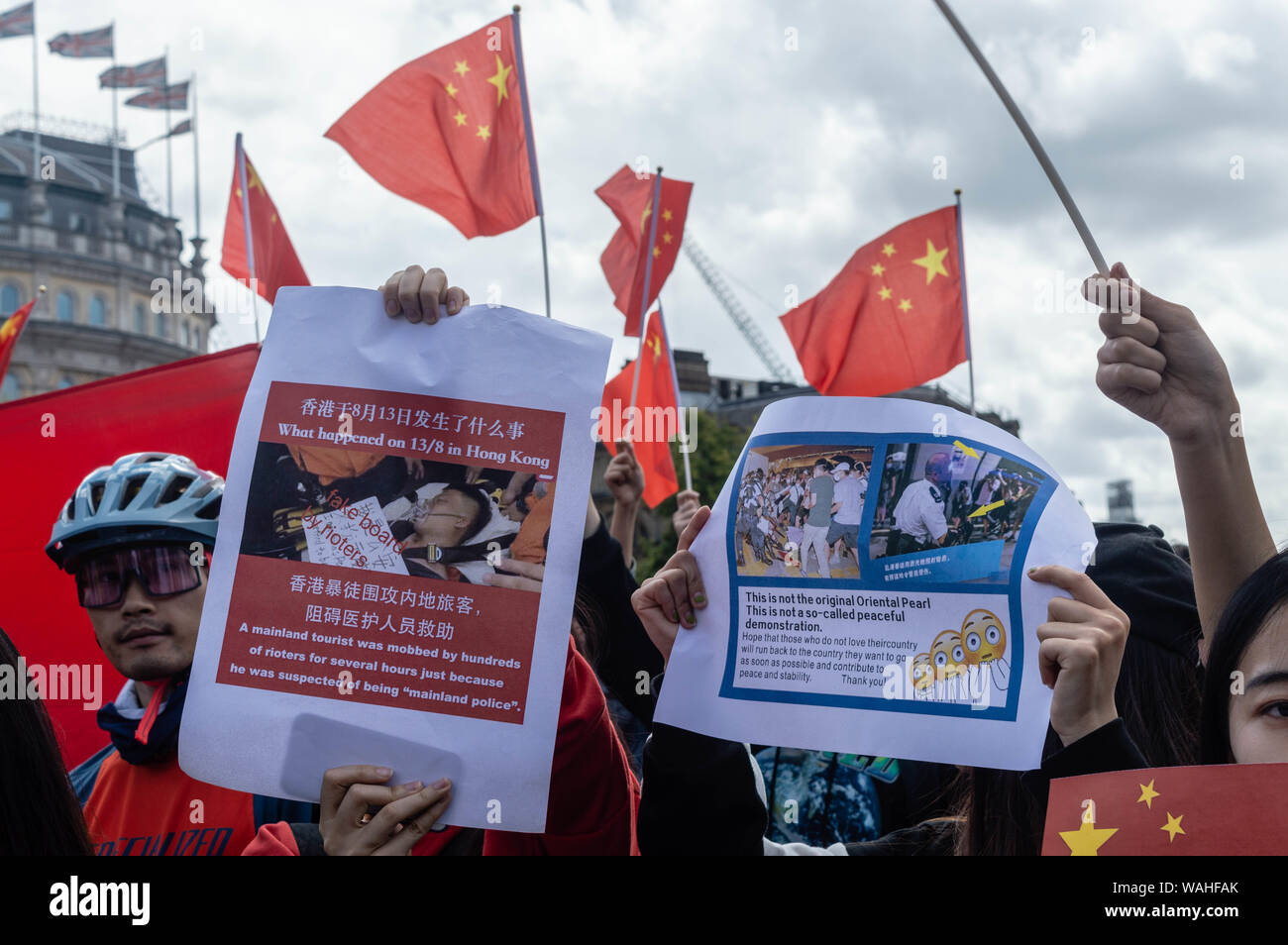 London, United Kingdom - August 17,  2019: Opponents of the UK Solidarity with Hong Kong rally holding up posters Stock Photo