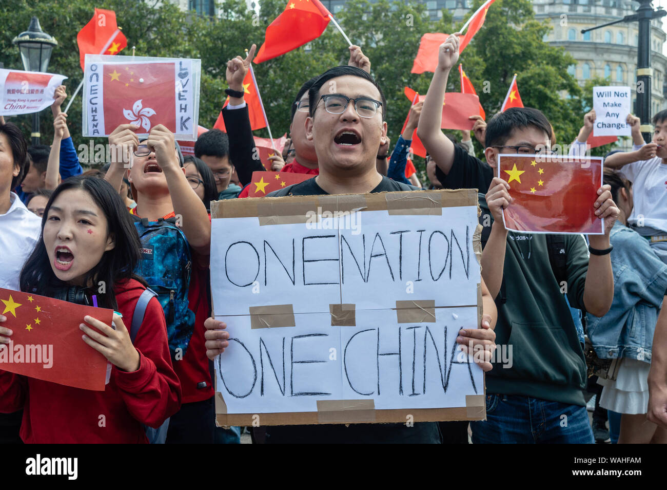 Chinese national holding a 'One Nation. One China.' banner at the UK Solidarity with Hong Kong rally. Stock Photo