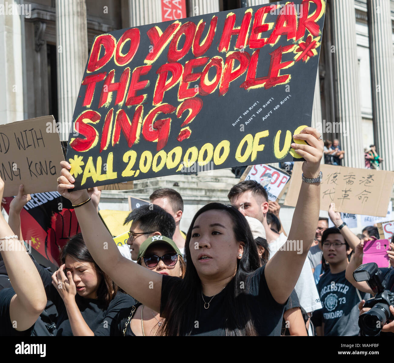 London, United Kingdom - August 17,  2019: Woman holding a banner in support of Hong Kong at the UK Solidarity with Hong Kong Rally. Stock Photo