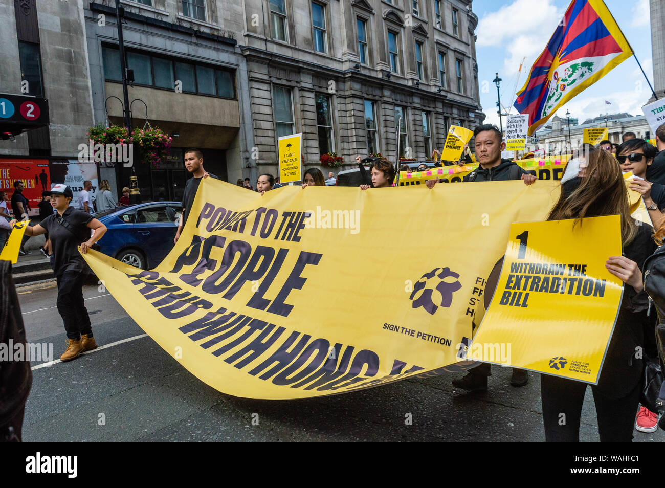 London, United Kingdom - August 17,  2019:  Protesters carrying a huge banner that states 'Power to the people. Stand with Hong Kong' at the UK Solida Stock Photo
