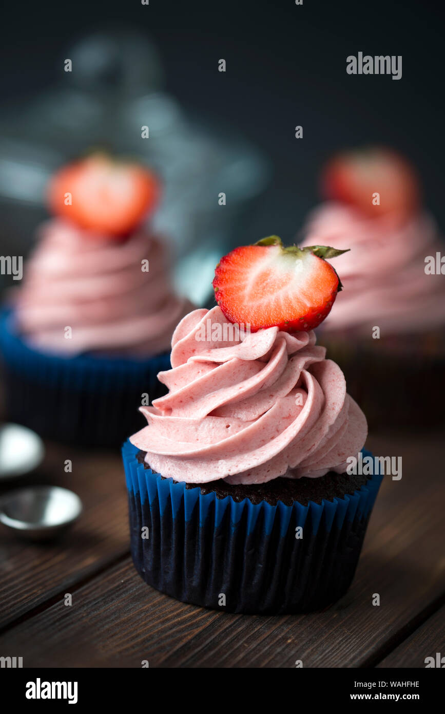 Chocolate cupcakes with strawberry meringue butter cream Stock Photo