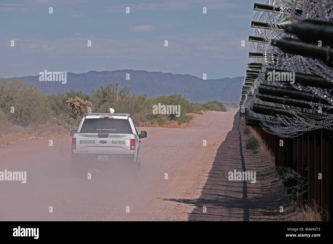 August 19, 2019, Lukeville, Arizona, US: US Border Patrol along the border fence in Lukeville, Arizona. This two mile portion of the fence will be torn down starting this week and replaced by 30 foot tall steel Bollard wall. 38.6 miles of the existing vehicle barriers that runs along the border with Mexico in the Cabeza Prieta National Wildlife Refugee and Organ Pipe Cactus Monument will be replaced by a wall but the work has been postponed until October. Various environmental groups have sued to halt construction and matter is back before a Federal judge. The Supreme Court has allowed the Tru Stock Photo