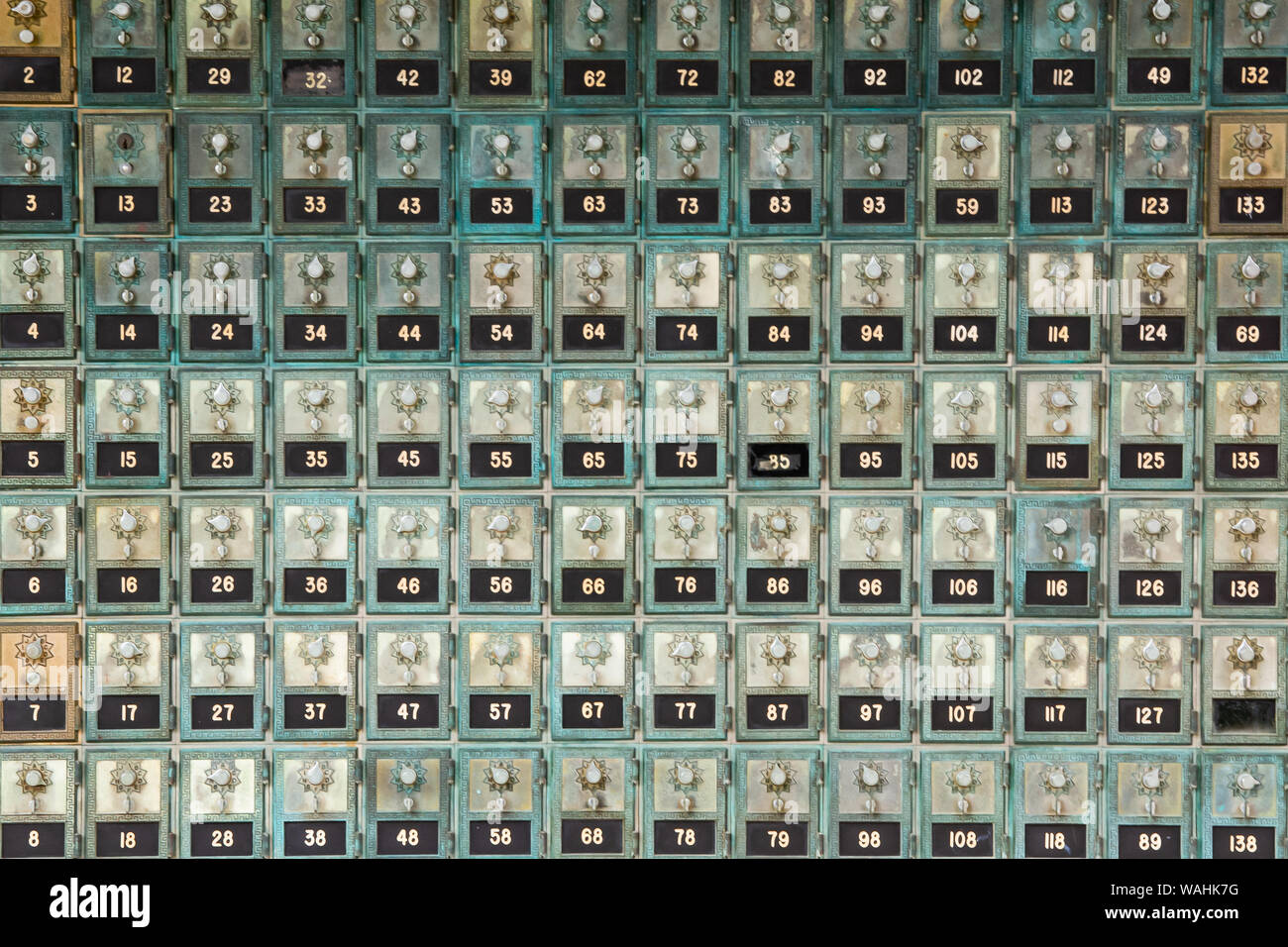 A wall of antique restored and unused mail boxes with combination locks on display in Speculator, NY USA Stock Photo