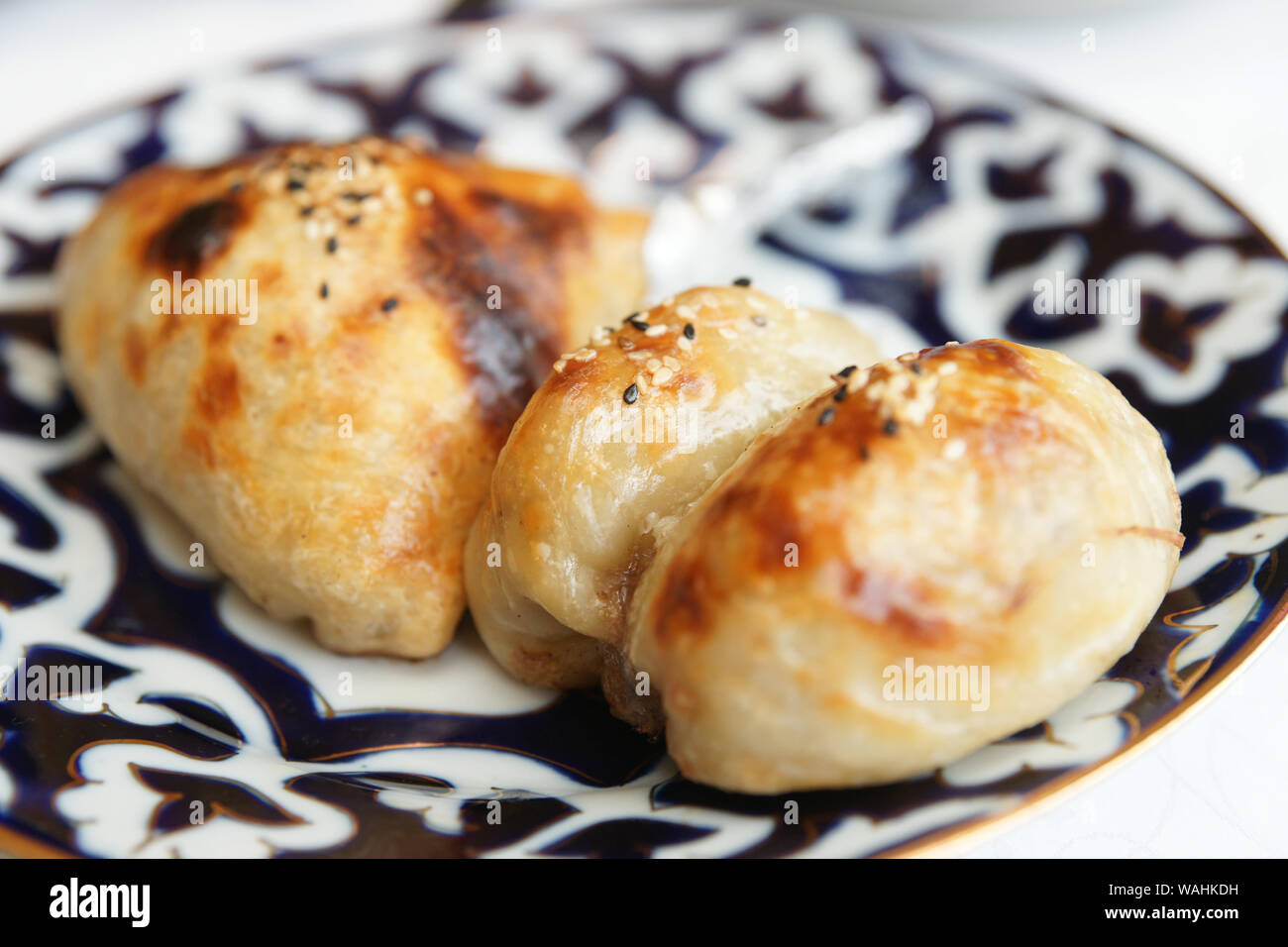 Oven-baked samosa stuffed bun, Uzbek food staple Stock Photo