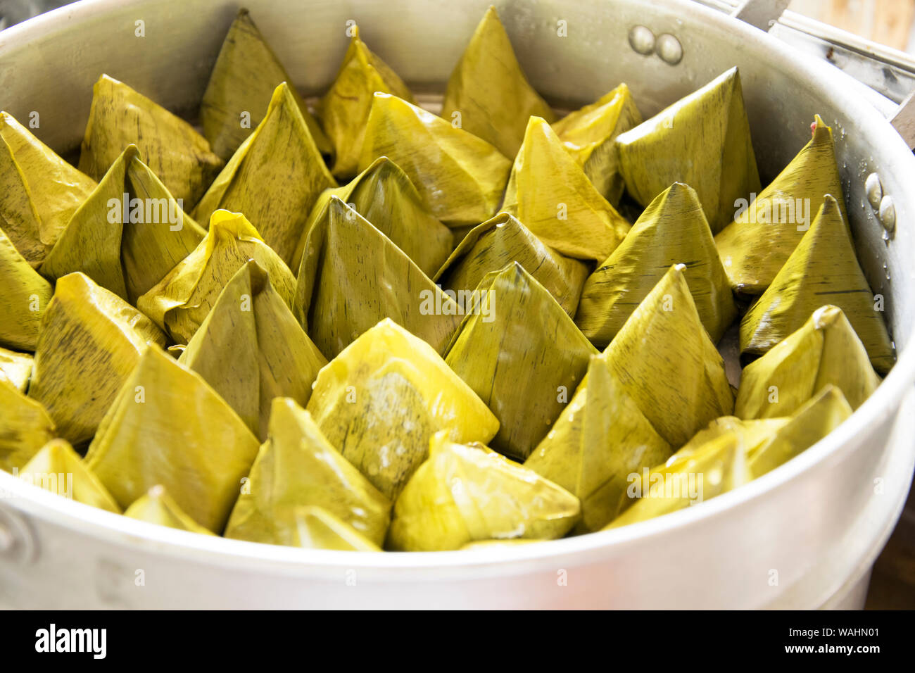 Thai dessert, made of rice flour and coconut with sugar ,Banana leaf wrap (cooked Stock Photo