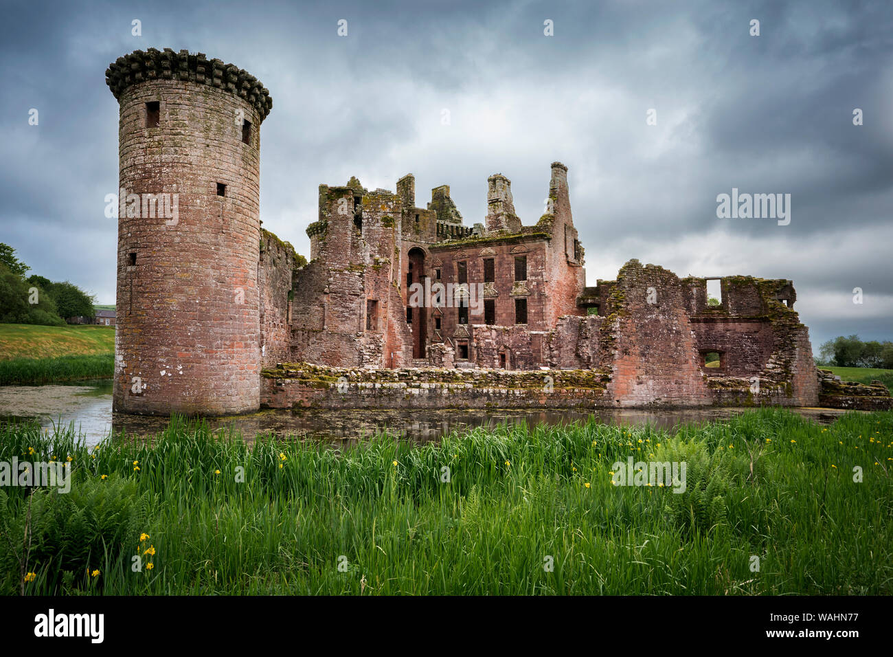 Back view of moated triangular Caerlaverock Castle in Scotland. Back wall was destroyed in the last battle with Covenanter army in 1640, leaving the c Stock Photo