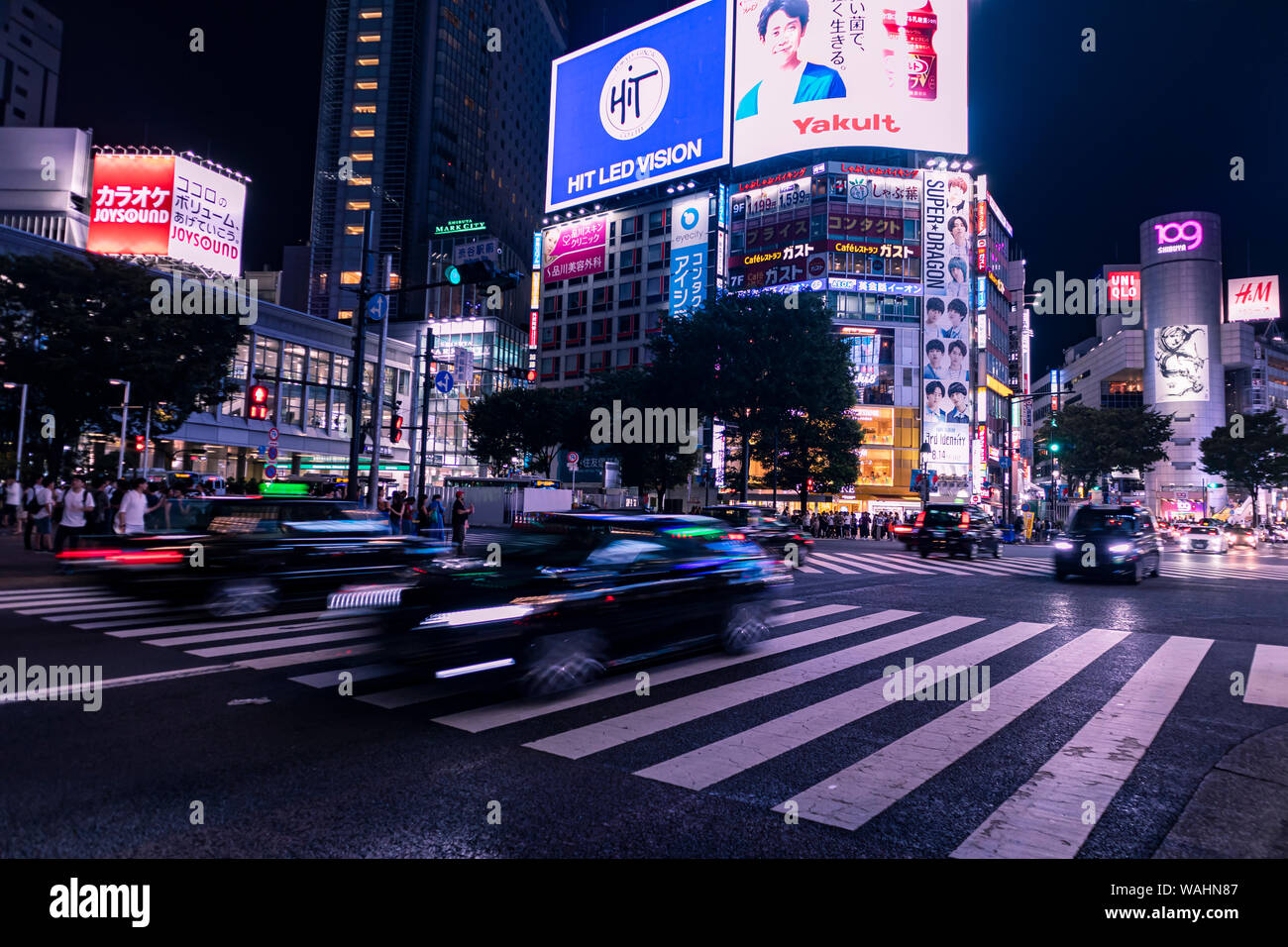 TOKYO, JAPAN - August 20, 2019 : Shibuya Scramble Crossing at night. Motion blur. Selective Focus. Stock Photo
