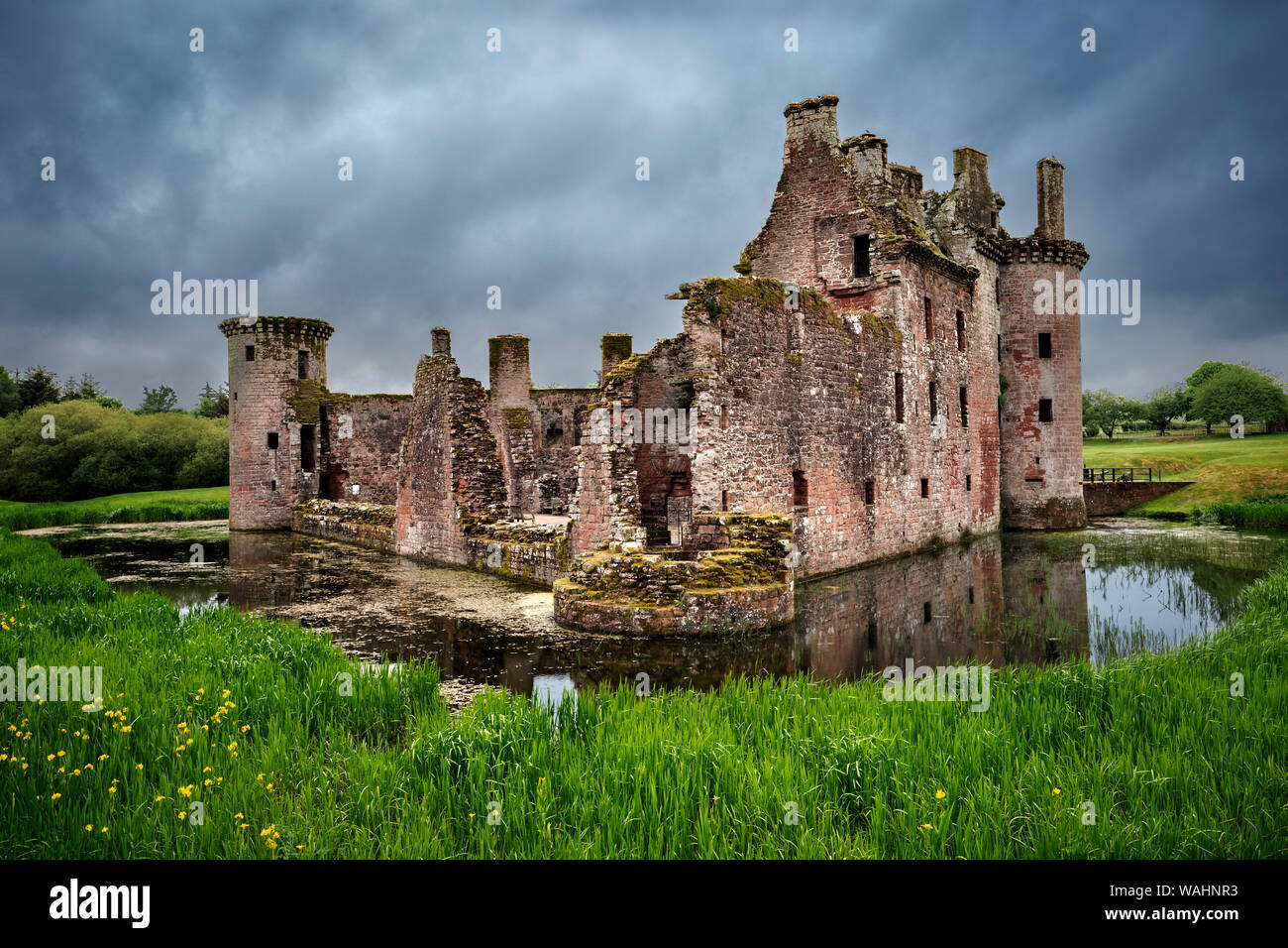 Back view of moated triangular Caerlaverock Castle in Scotland. Back wall was destroyed in the last battle with Covenanter army in 1640, leaving the c Stock Photo