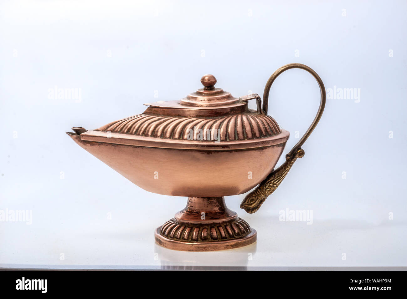 31 Jan 2005 Vintage Grant a wish, desiring financial wealth with a old golden magic lamp isolated on white background with clipping path studio shot K Stock Photo