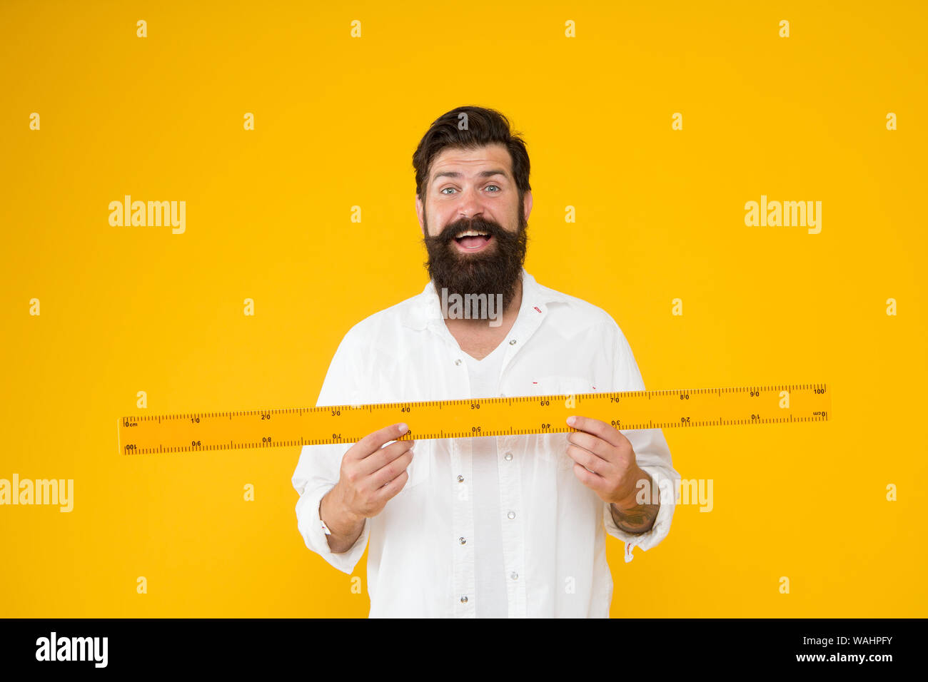 Actual size. School teacher. Small little big large. Does size really  matter. Man bearded hipster holding ruler. Measure length. Size tall and  length. Big size. Measure and control. Geometry theorem Stock Photo -