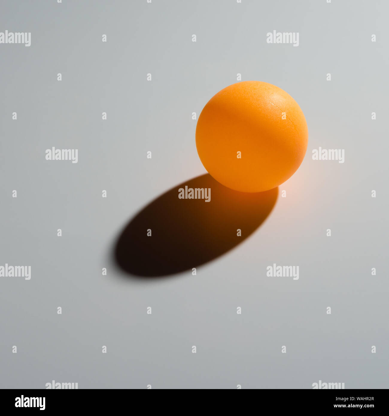 yellow pingpong ball on grey background Stock Photo