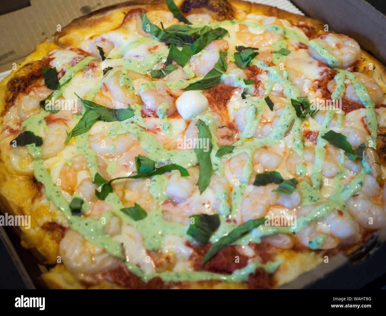 A water pizza (shrimp, crab, basil pesto) from Steveston Pizza Company in Steveston Village, Richmond, British Columbia, Canada. Stock Photo