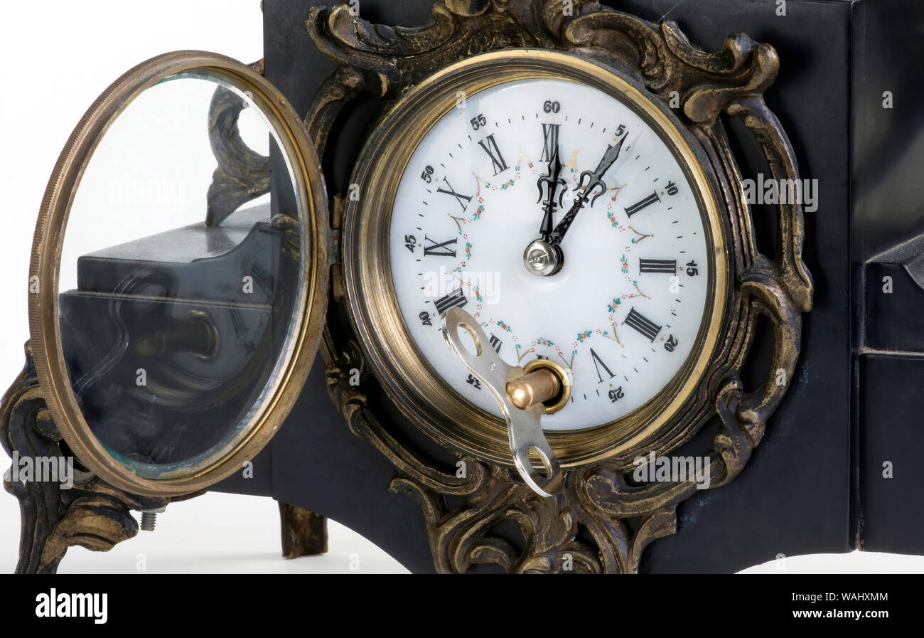 Close-up of clock winding key on 19th century french bronze clock. You would wind up clock ever seven days. Stock Photo