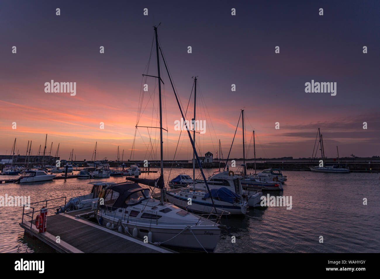 Boats in Victoria Dock at dusk at Caernarfon, North Wales Stock Photo