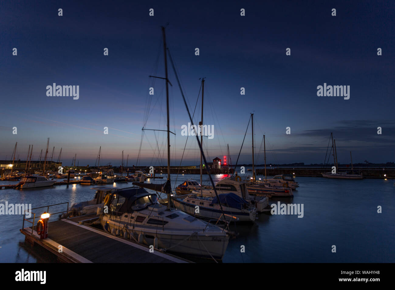 Boats in Victoria Dock at twilight at Caernarfon, North Wales Stock Photo