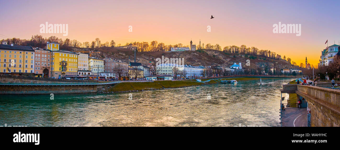 SALZBURG, AUSTRIA - FEBRUARY 27, 2019: The embankment of the medieval Altstadt district during amazing sunset time, on February 27 in Salzburg Stock Photo