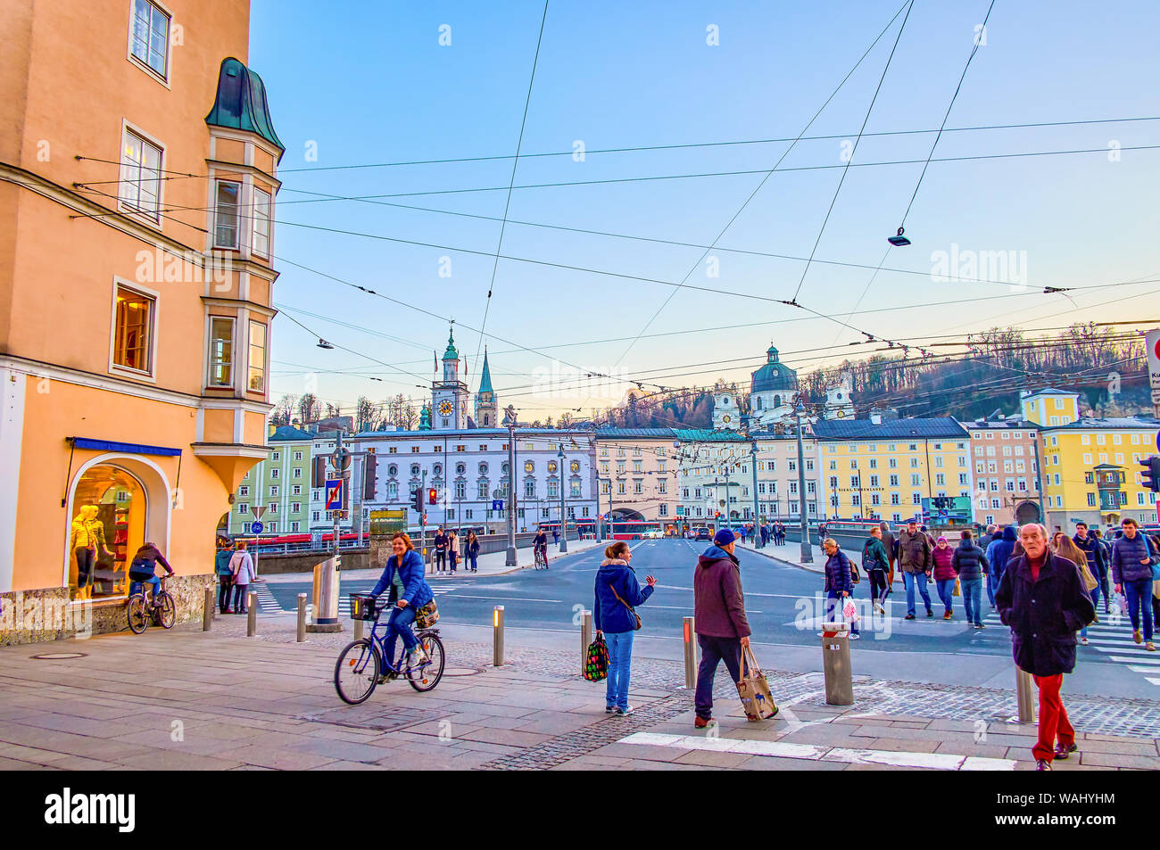 SALZBURG, AUSTRIA - FEBRUARY 27, 2019: The crowded crosswalk at the busy Staatsbrucke bridge, connecting historical neighborhoods, located across the Stock Photo