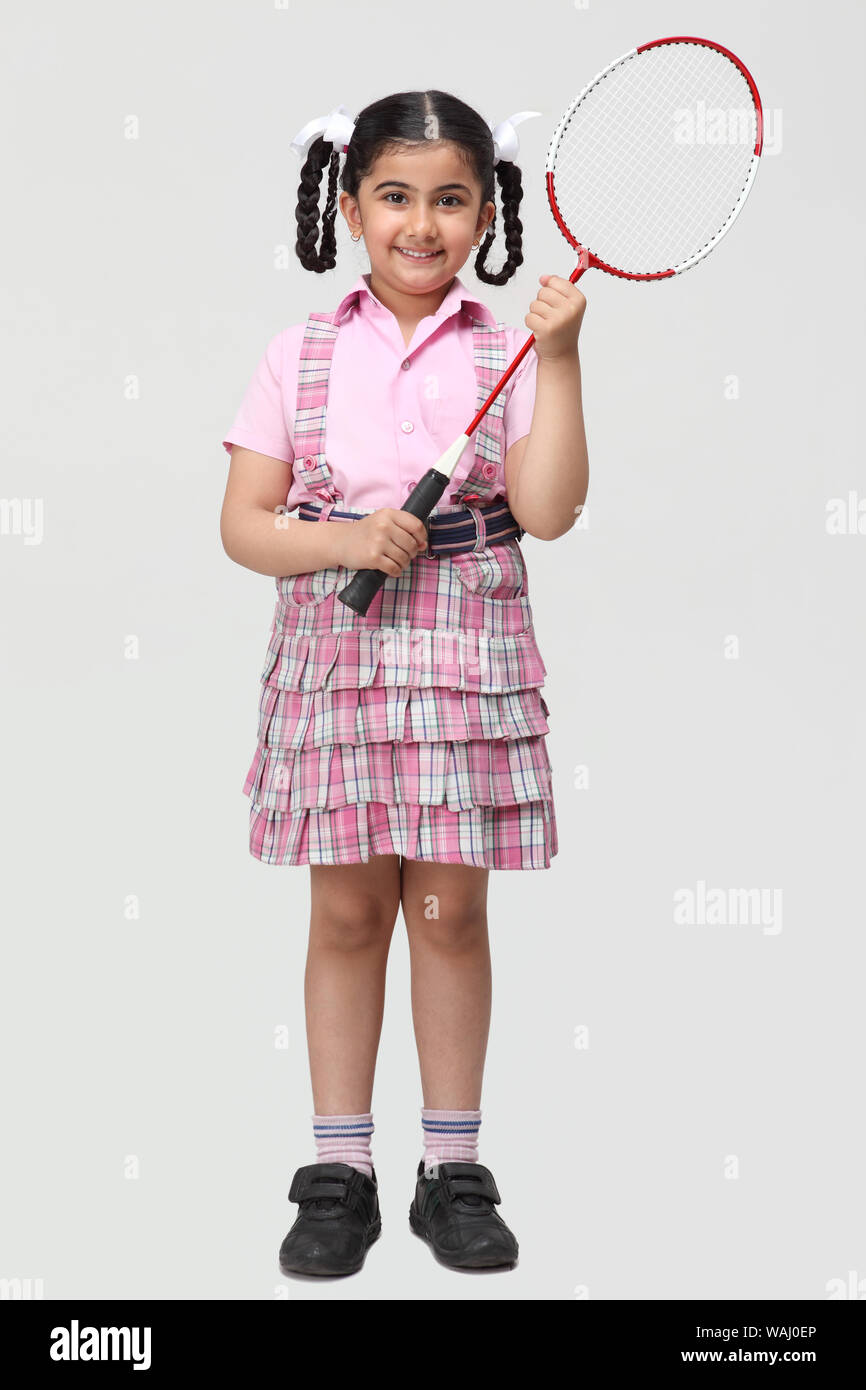 Schoolgirl playing badminton Stock Photo