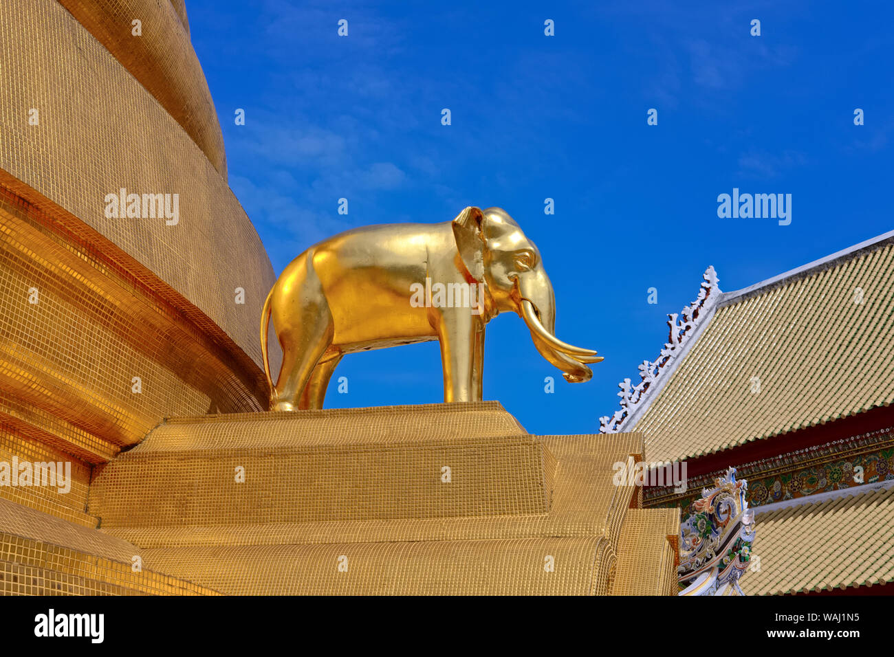 A golden elephant statue by the central golden chedi (stupa) of Wat