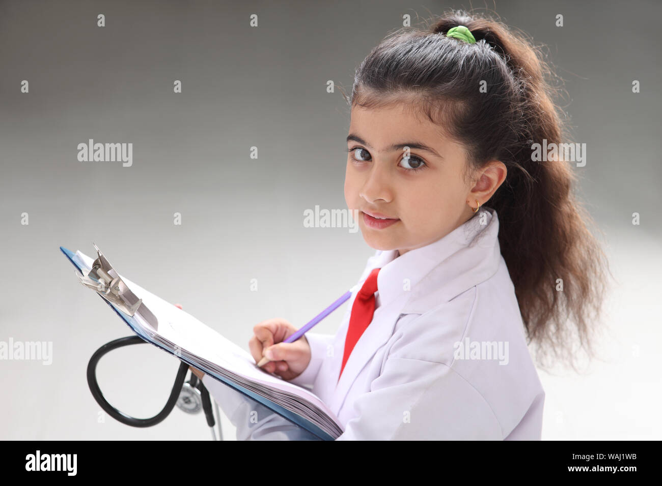Girl pretending to be a doctor holding medical report Stock Photo Alamy
