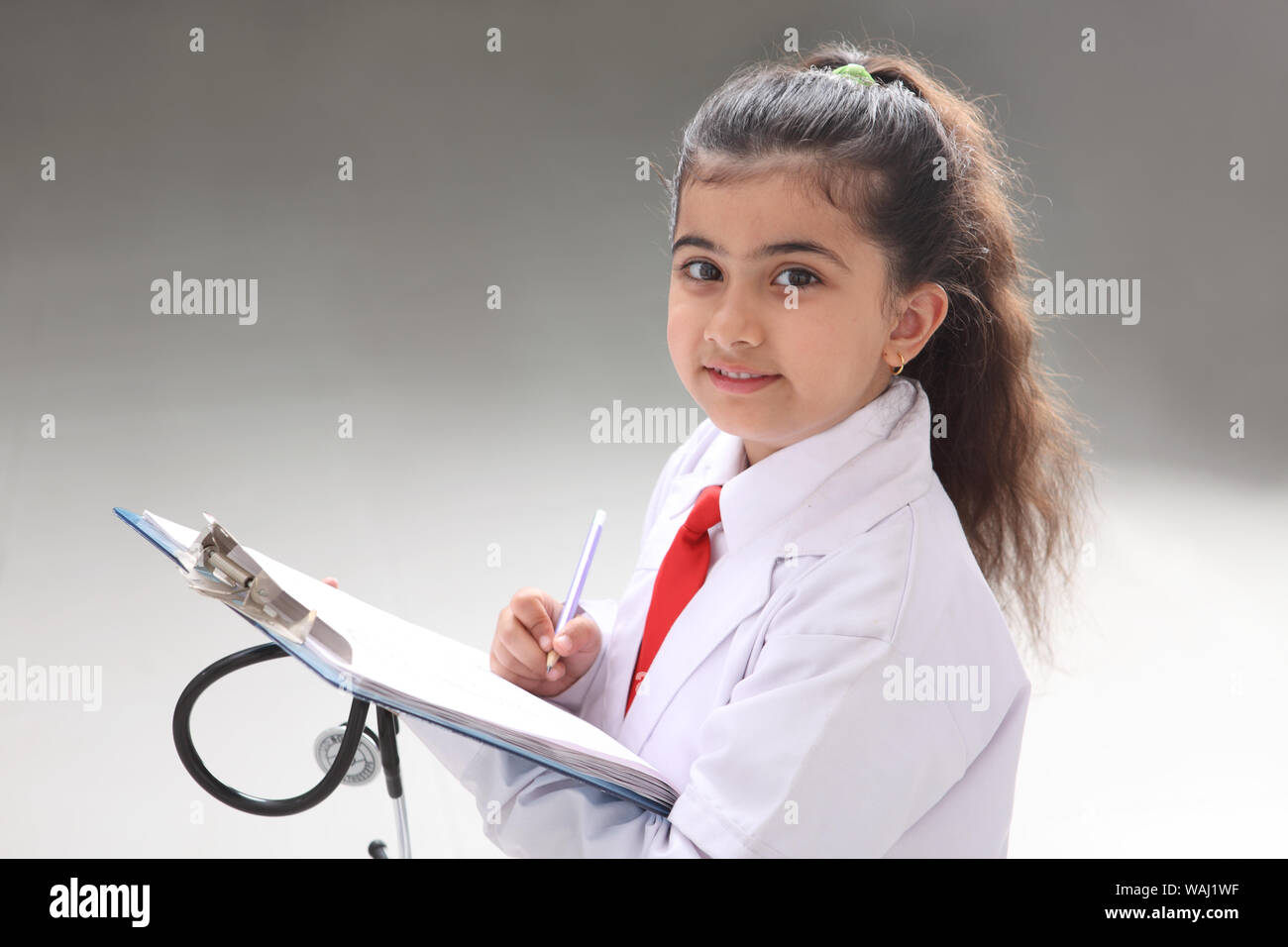 Girl pretending to be a doctor holding medical report Stock Photo Alamy