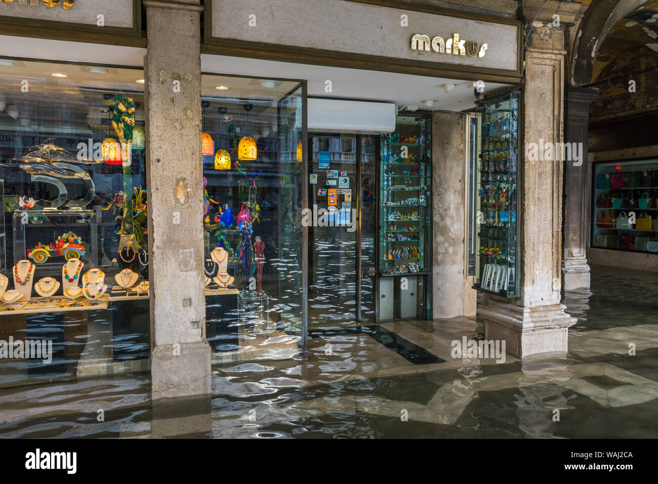 Flooded shop front at the Procuratie Vecchie arcades during an Acqua alta (high water) event, Saint Mark's Square, Venice, Italy Stock Photo