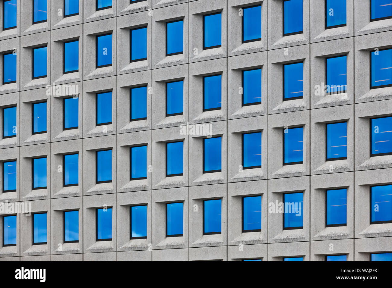 Modern concrete building facade with geometric windows. Contemporary ...