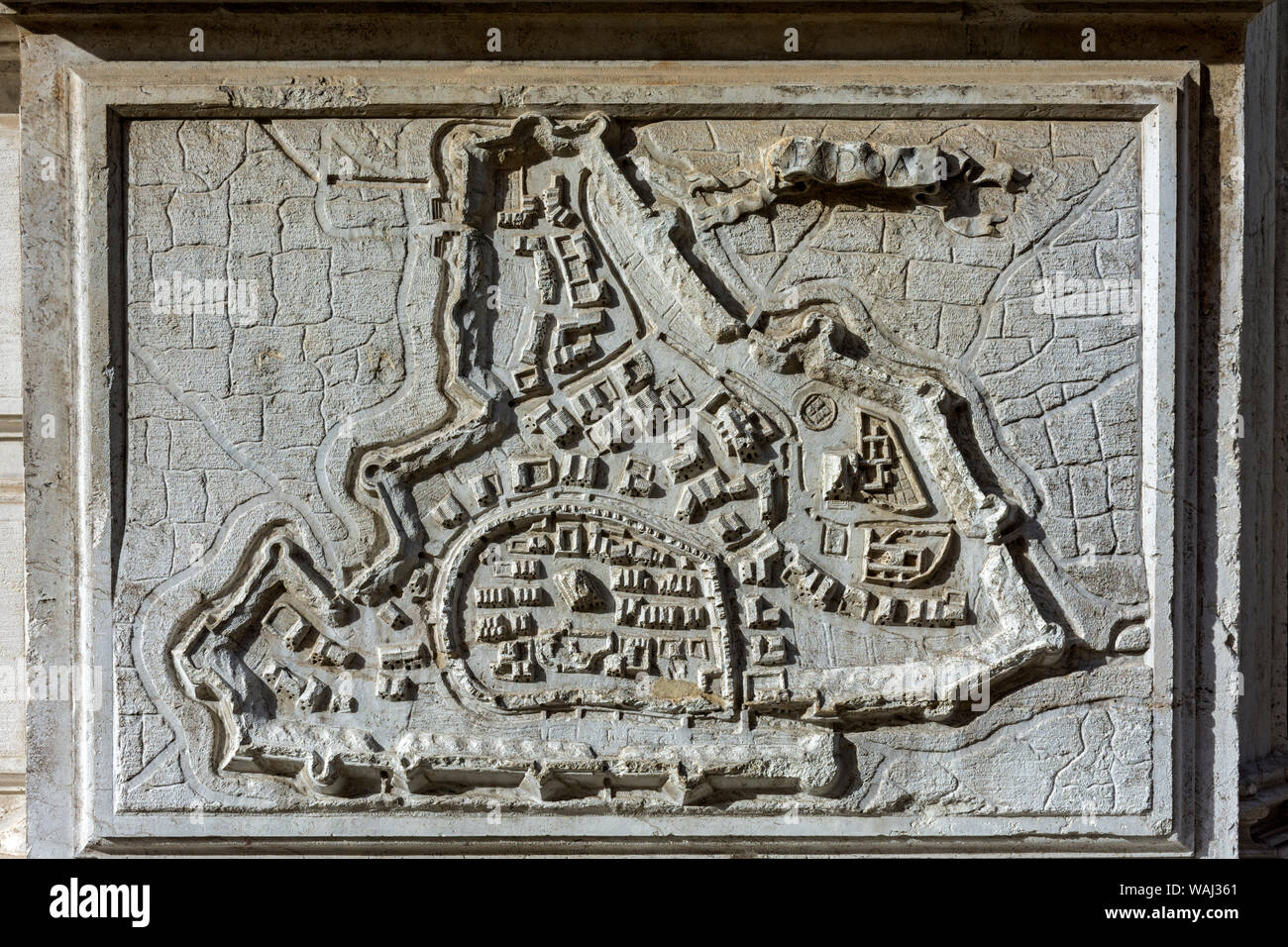 Carved stone relief map of Padua on the façade of the church of Chiesa di Santa Maria del Giglio (St. Mary of the Lily), Venice, Italy. Stock Photo