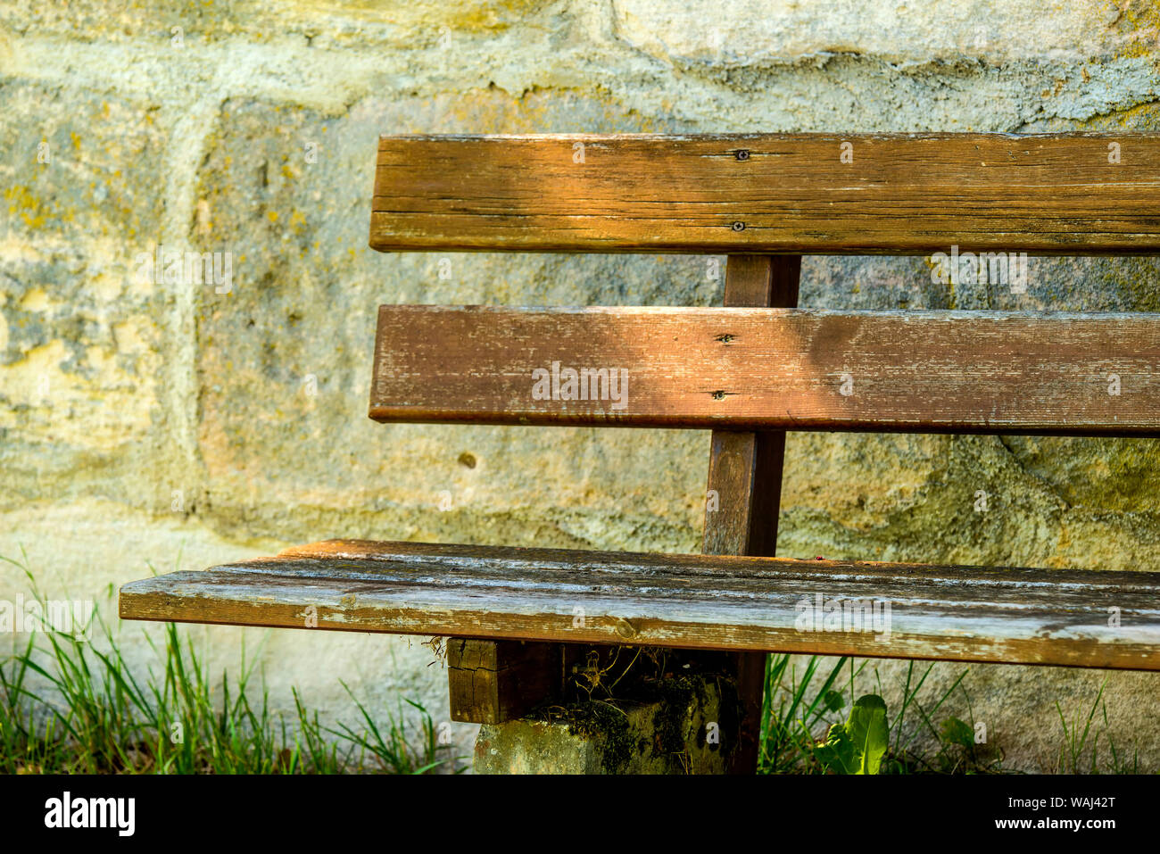 park bench at an old antique abbey wall Stock Photo - Alamy