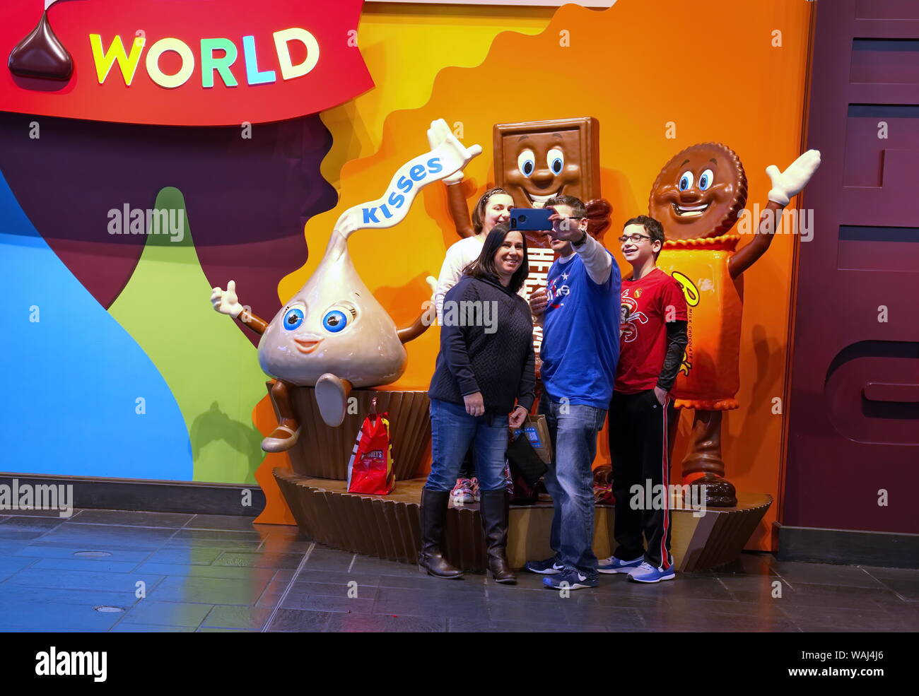 Hershey, PA USA. Mar 2019. Friends and family posing and taking cellphone pictures at Chocolate World. Stock Photo