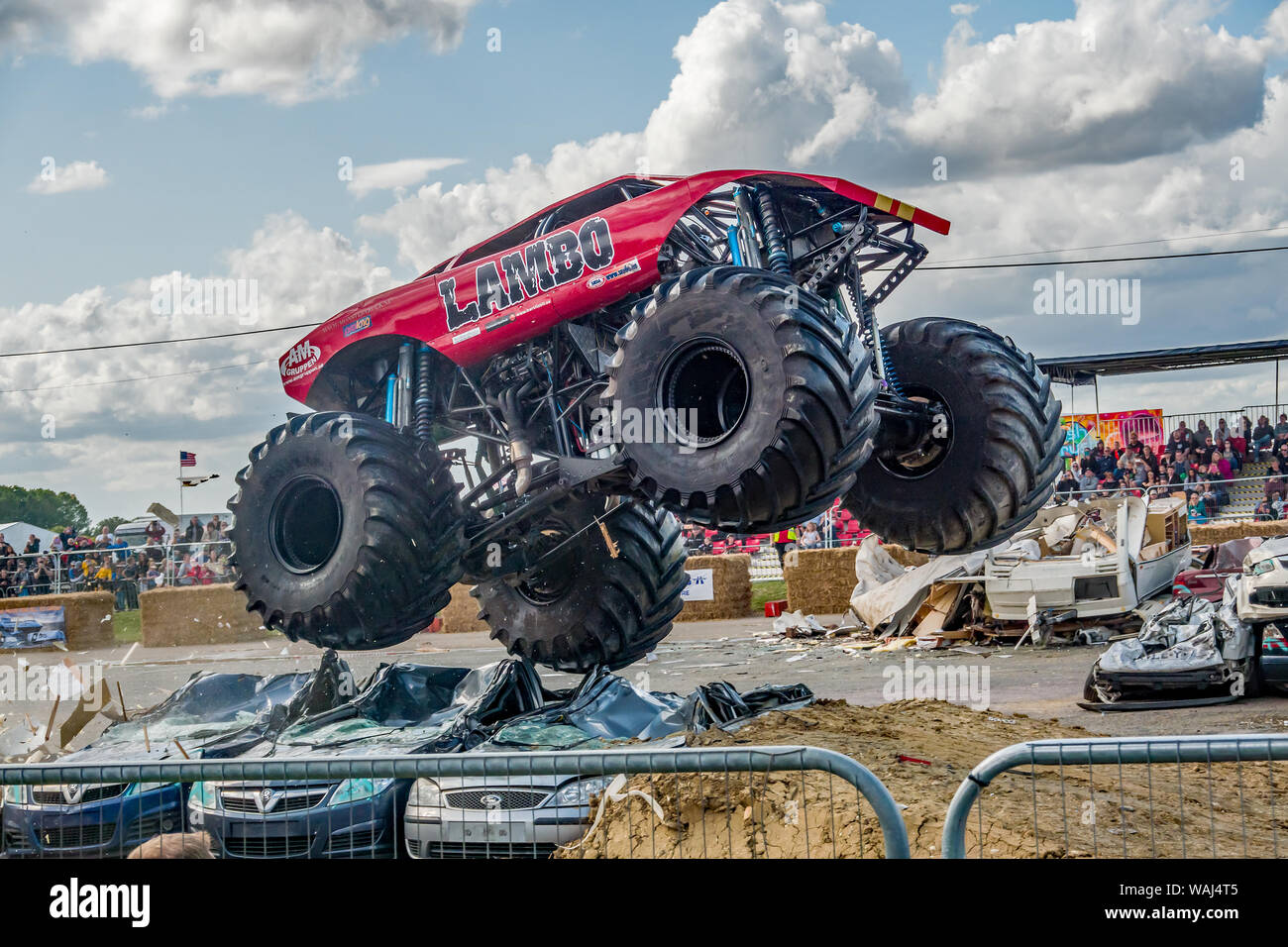 The Lambo monster truck airborne whilst jumping over a stack of scrap cars  during a demonstration at a monster truck show Stock Photo - Alamy