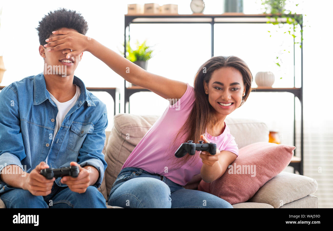 Teenage Couple Enjoying Playing Videogame On Playstation Stock Photo