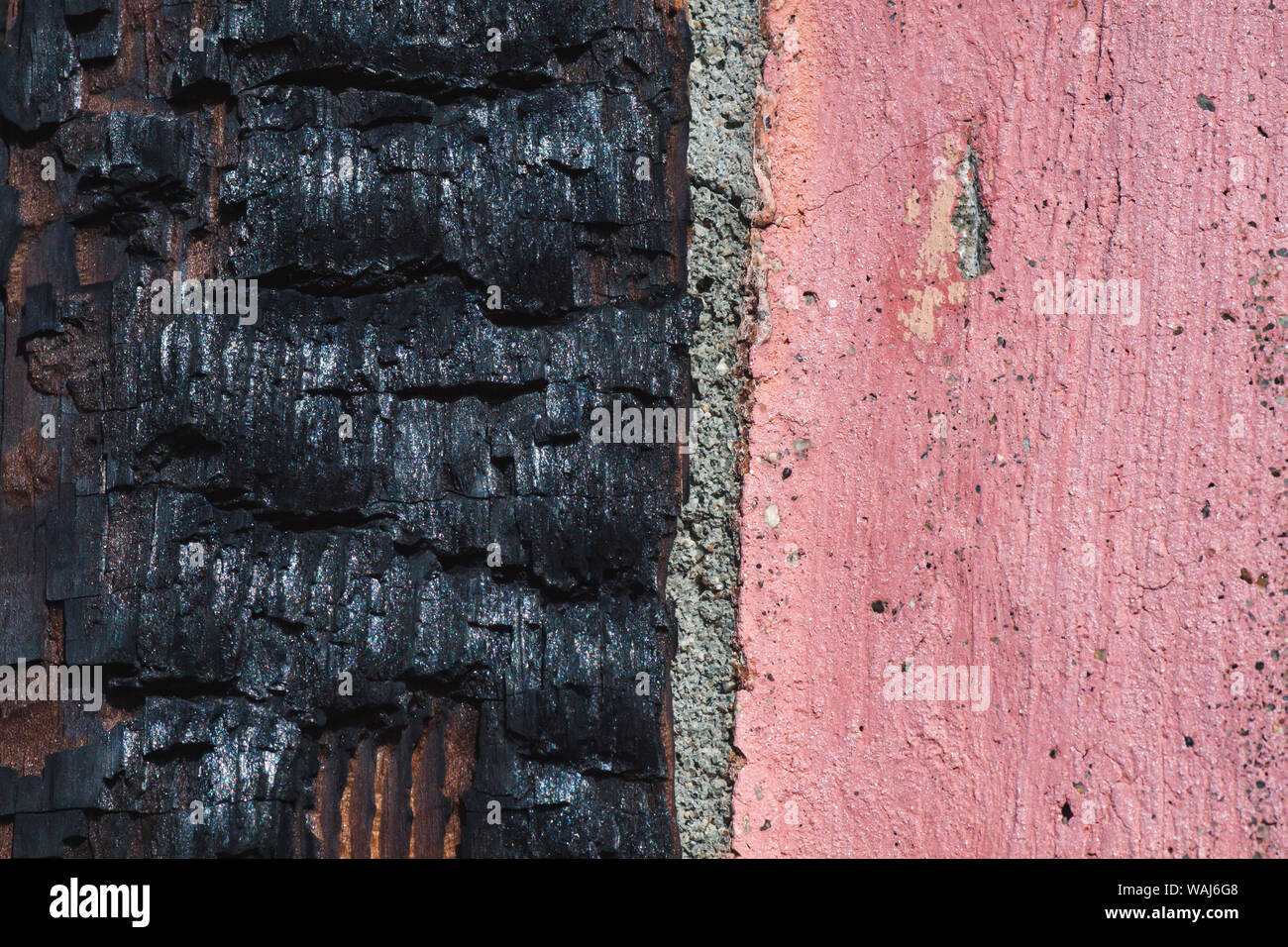 Burnt wood and cement wall. Stock Photo