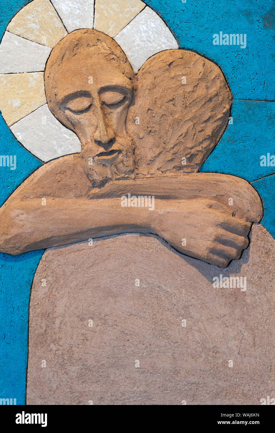 A relief sculpture of Jesus Christ embracing a person. Made out of modelling clay by Lubo Michalko. Displayed in the Quo Vadis Catholic House. Stock Photo