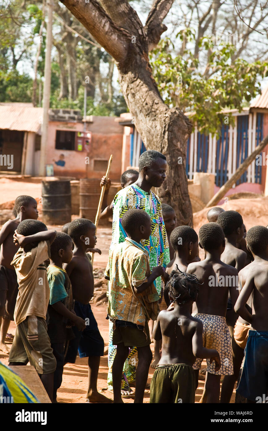 West Africa, Benin. Children gathered around man before Gelede Mask Dance. Stock Photo