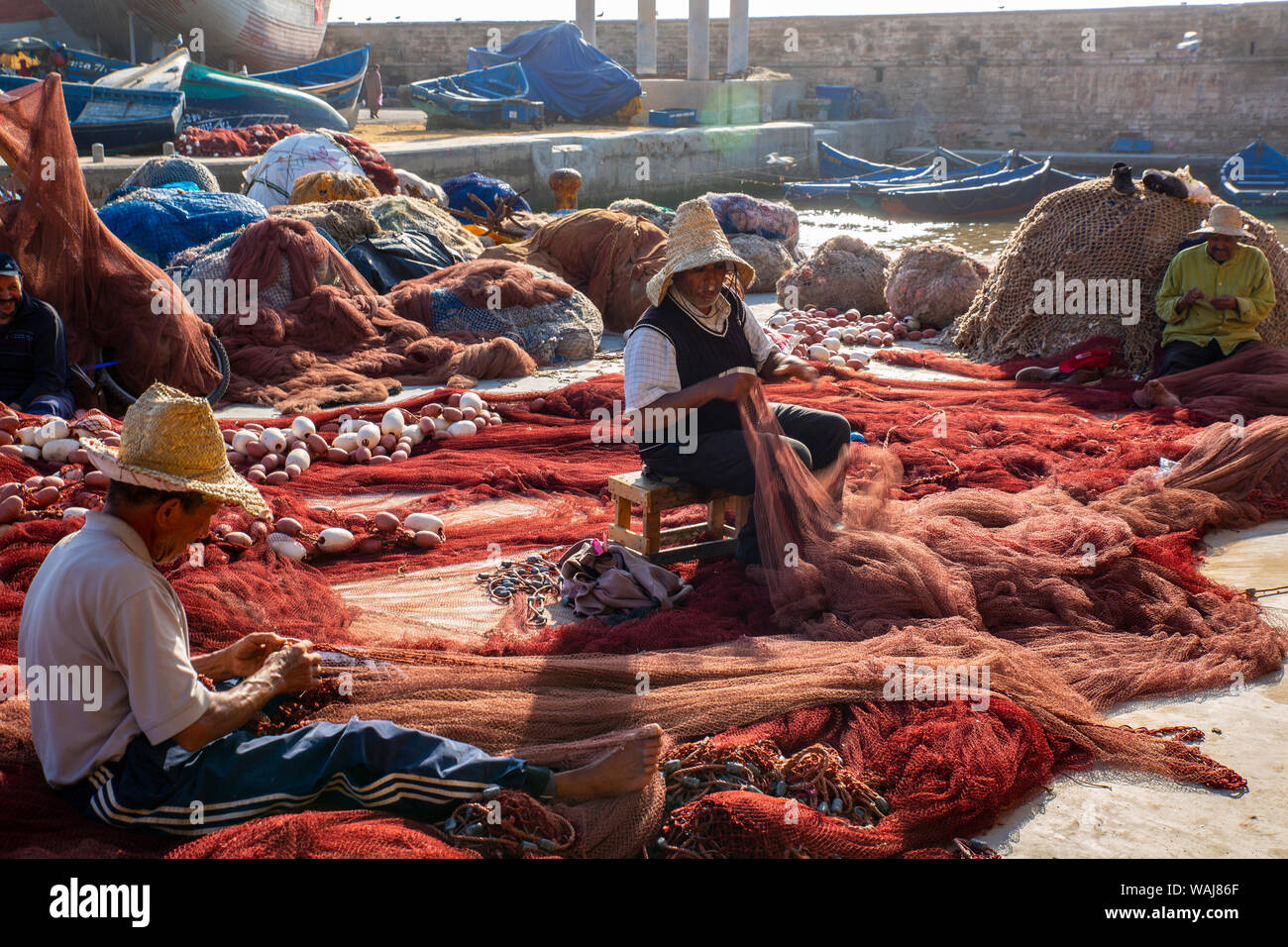 Essaouira, Morocco. Fishermen repairing fish nets Stock Photo