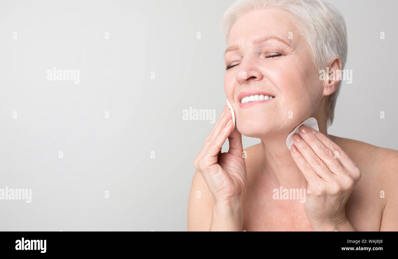 Senior woman enjoying her beauty and face care routine Stock Photo Alamy