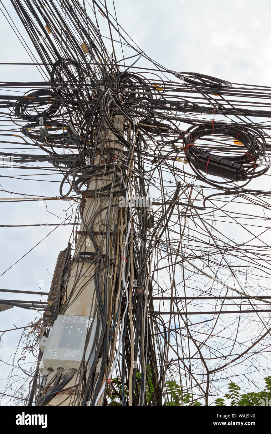 Phnom Penh, Cambodia. Rat's nest of electrical wiring. This is along one of Phnom Penh's streets. Stock Photo