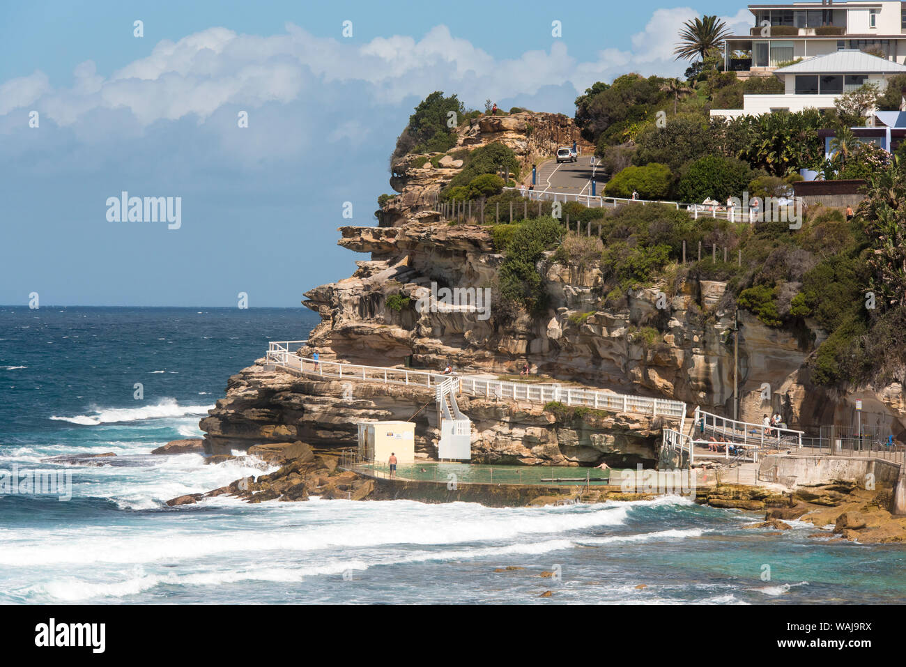 Australia, New South Wales, Sydney Railing of Bondi to Coogee coastal walk on top of Hawkesbury sandstone cliffs overlooking Bronte Ocean Swimming Pool. Stock Photo