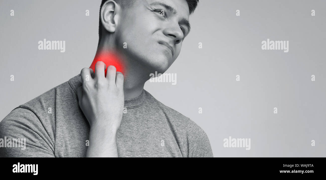 Young man scratching his neck, painful rash Stock Photo Alamy
