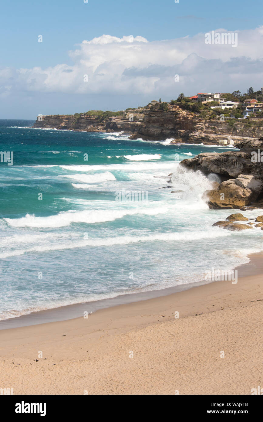 Australia, New South Wales, Sydney Waves crash against Hawkesbury Sandstone cliffs at Tamarama Beach on Bondi to Coogee walk Stock Photo